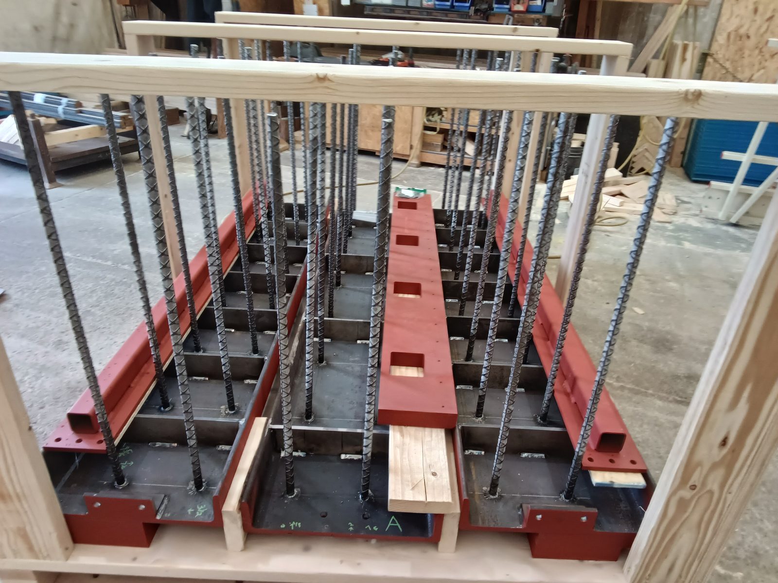 Primed steel embed frames with anchor studs, crated for delivery